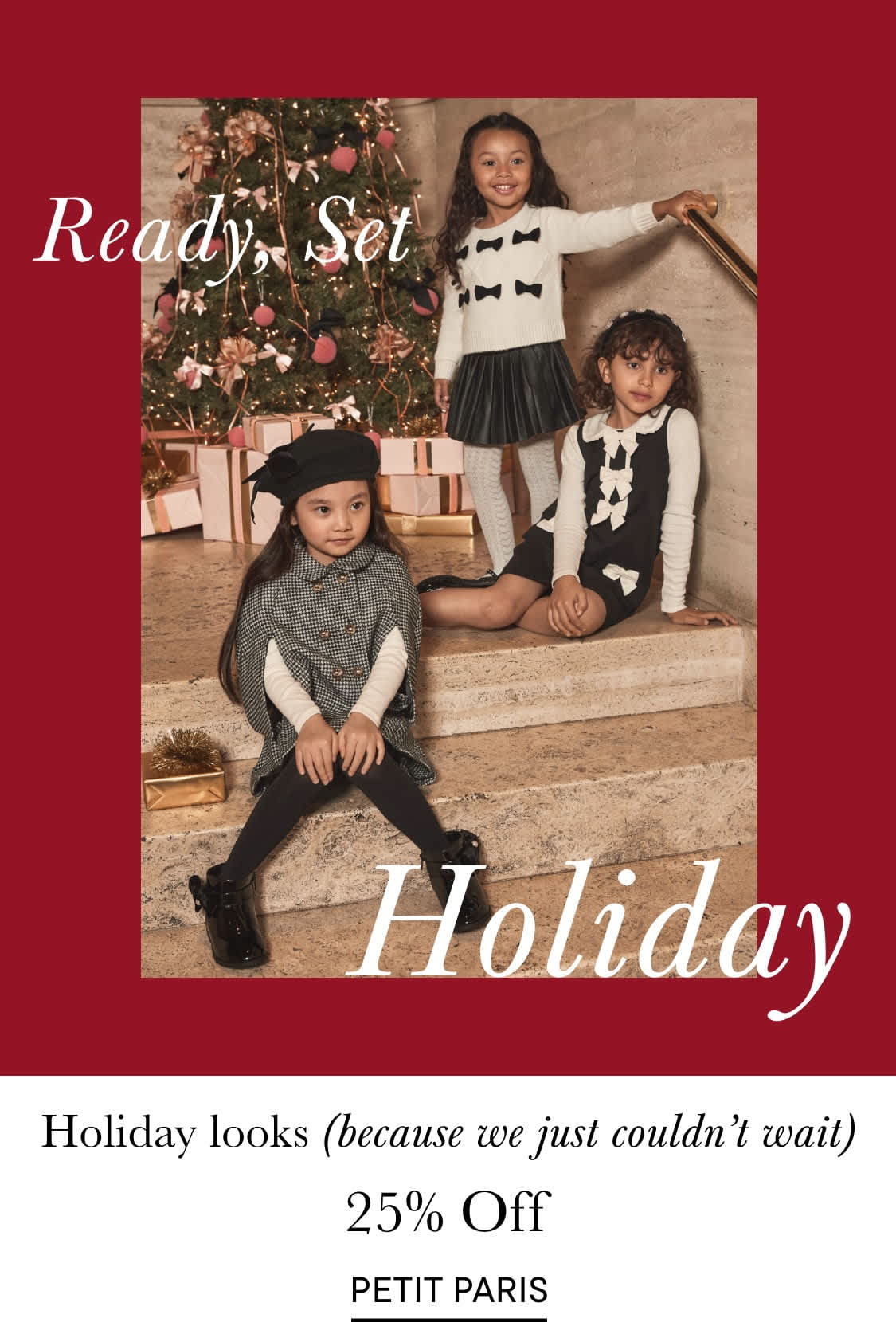The image depicts two young women walking up a staircase in a festively decorated setting, with a Christmas tree and other holiday decorations visible in the background.