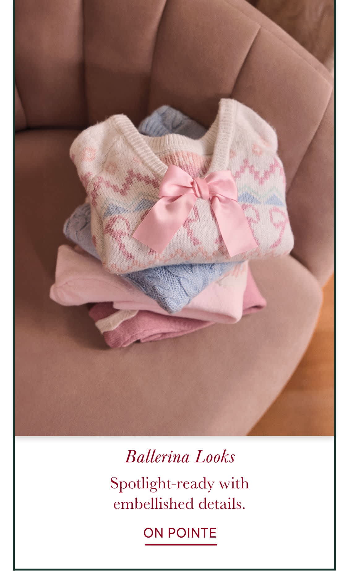 Soft, pastel-colored fabrics with a delicate bow adorn the foreground, creating a visually appealing and feminine aesthetic. The background appears to be a cozy, warm-toned setting, suggesting a serene and inviting atmosphere.