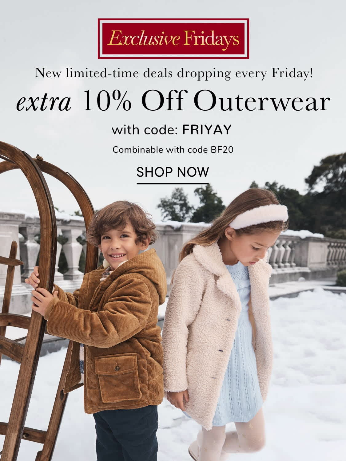 Two young women wearing warm winter coats stand in front of a red advertisement banner offering a discount on outerwear.