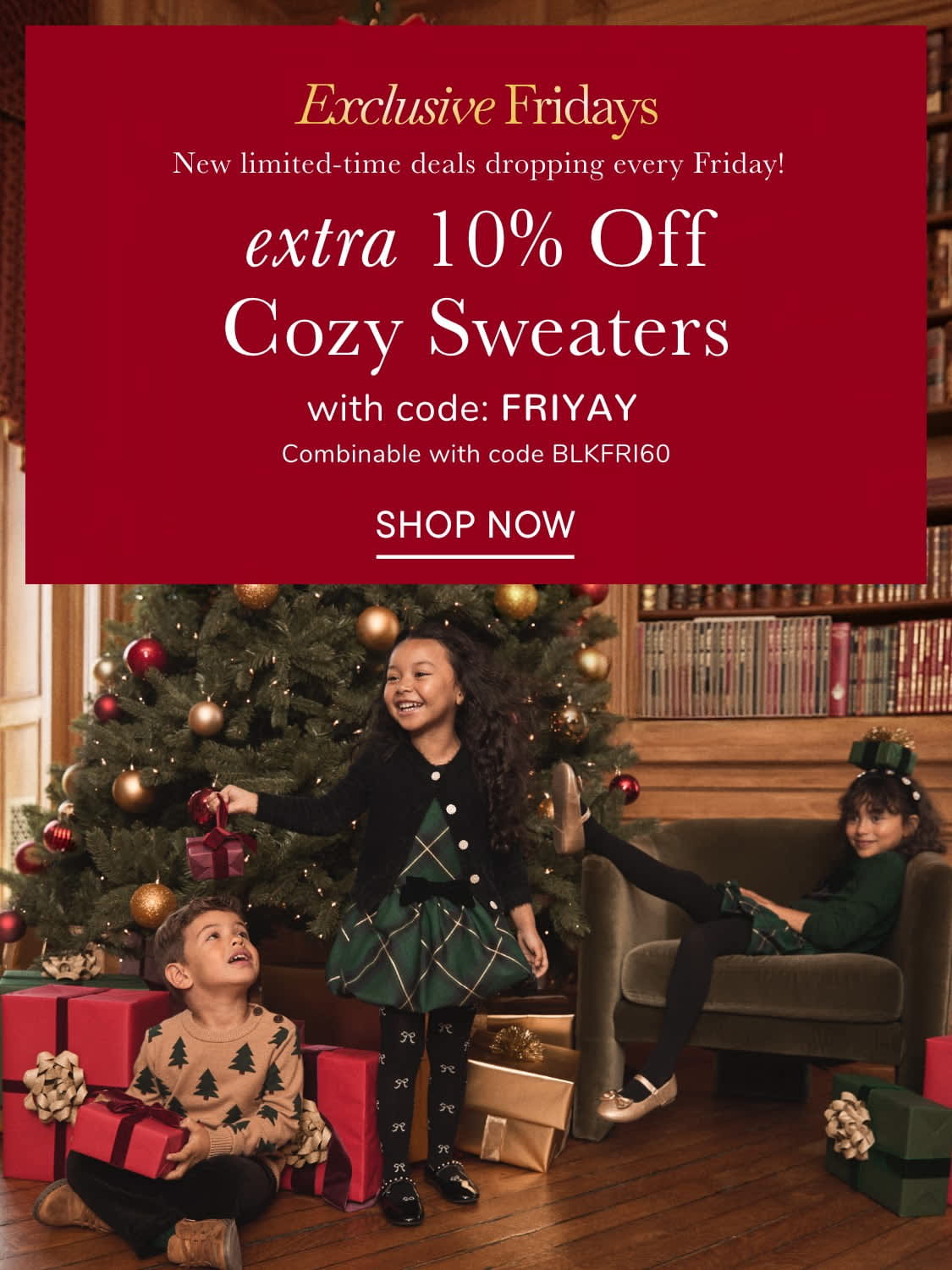 The image shows a family gathered around a Christmas tree, with a large red advertisement banner in the background promoting a sale on cozy sweaters.