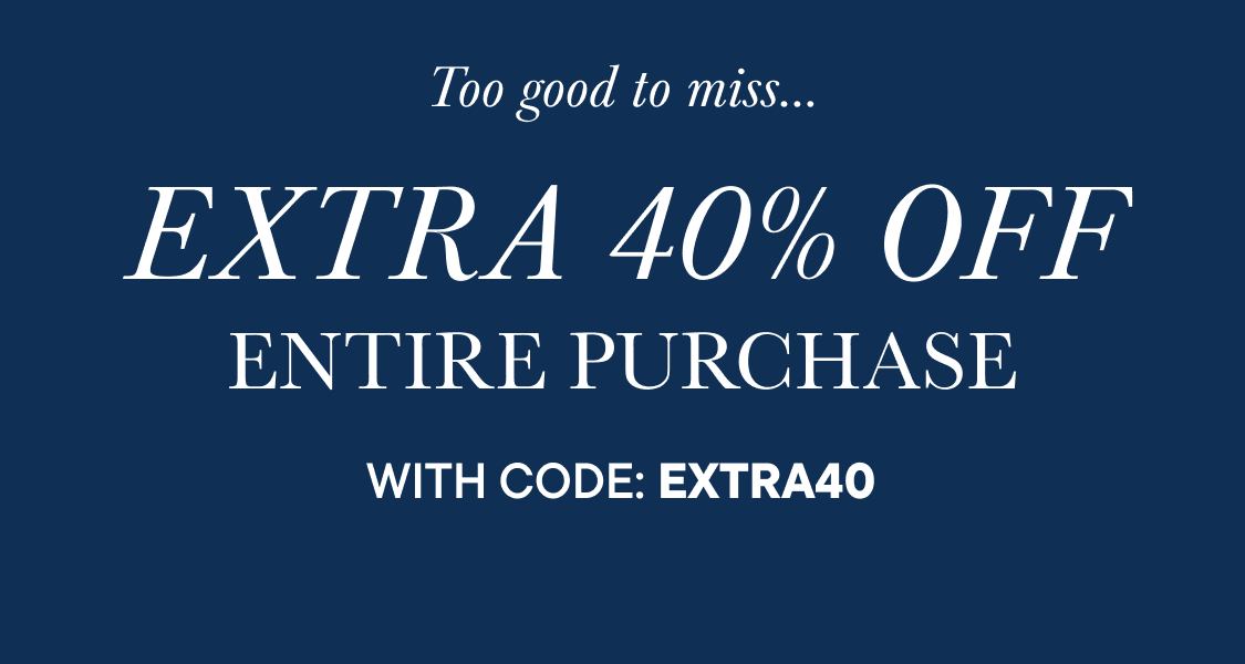 The image shows three young girls with diverse appearances, smiling and standing in what appears to be a cozy, book-filled room.