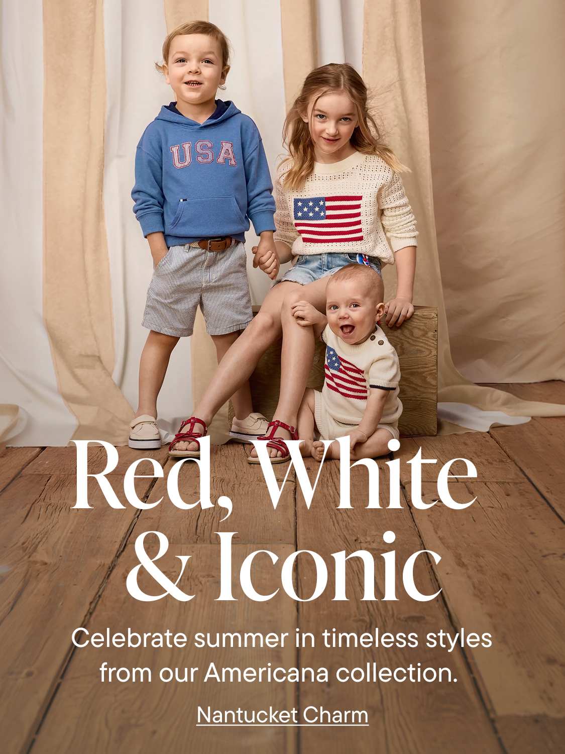 Three children in patriotic sweaters pose in front of a neutral-toned backdrop with text that reads "Red, White & Iconic."