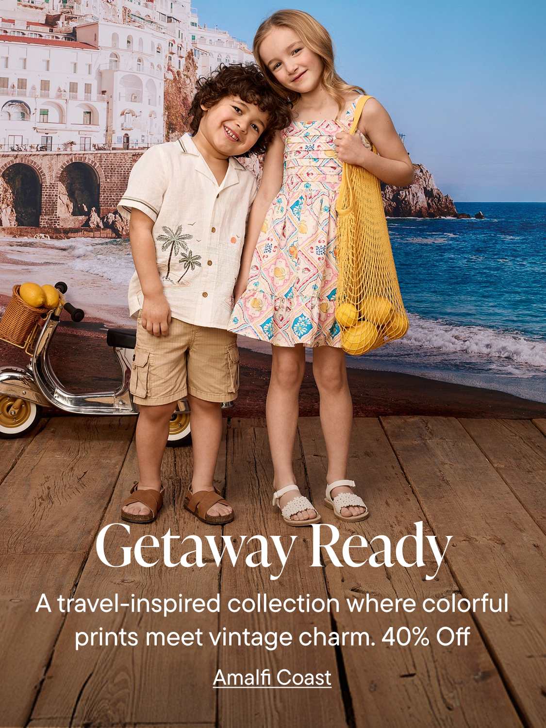 Two children stand on a wooden deck in front of a backdrop of a coastal Italian town and the sea, with text overlaying the scene.