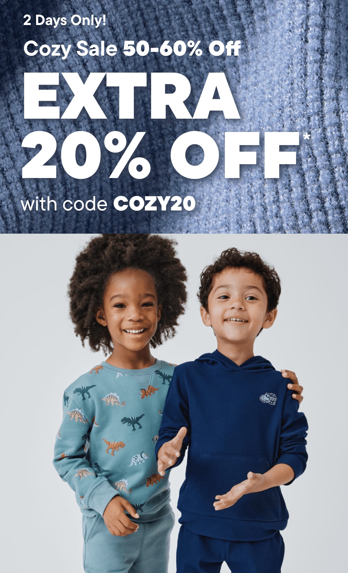 The image features two young children, a boy and a girl, standing together and smiling. The background is a gray, textured surface, and the image promotes a "Cozy Sale" with a 50-60% discount and an additional 20% off with the code "COZY20".