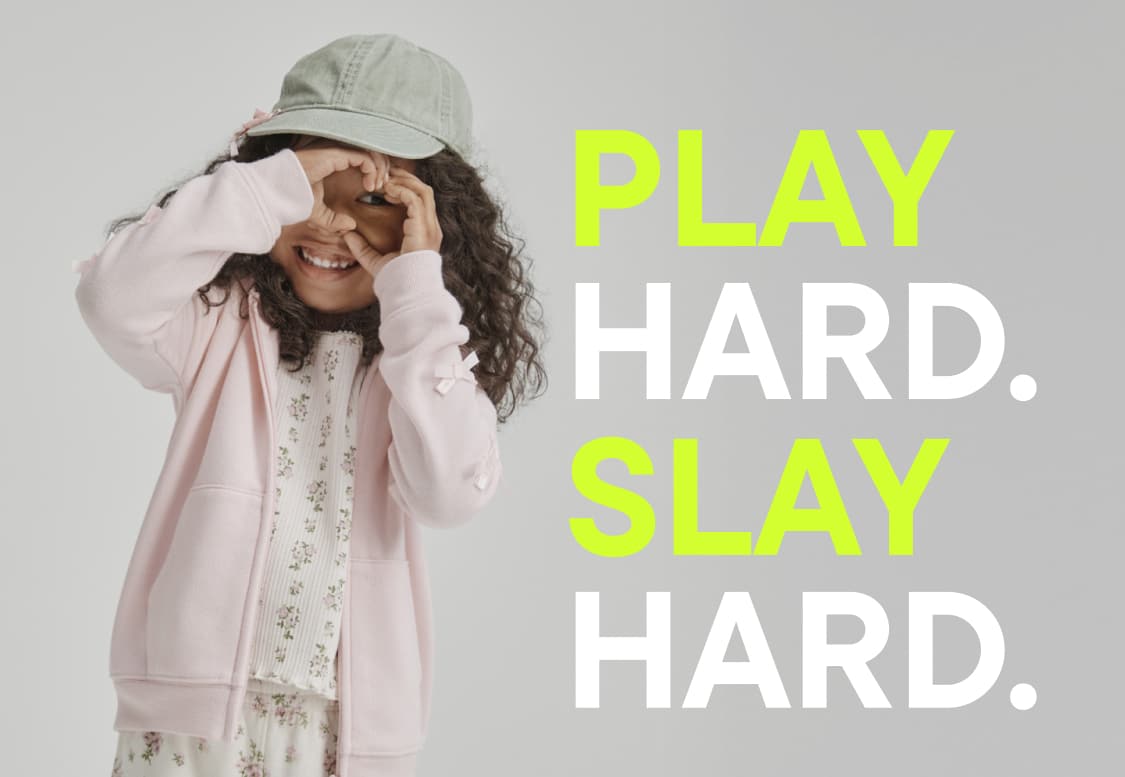 The image features a person with long, dark hair wearing a white shirt against a plain white background, with the text "PLAY HARD SLAY HARD" prominently displayed in bright neon green letters.