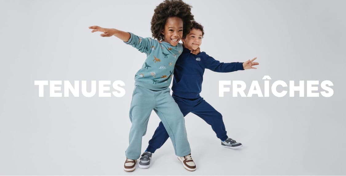 A young person with curly hair wearing a beige sweater stands against a plain white background with the text "FRESH FITS" prominently displayed.