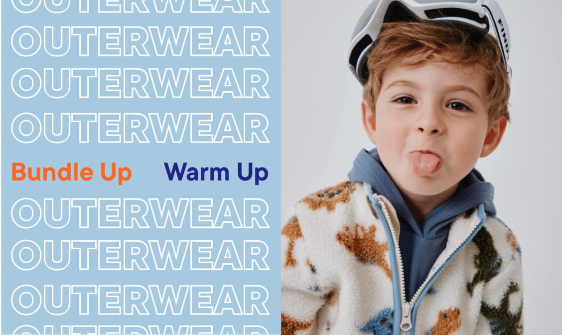 The image shows two people, a man and a woman, wearing warm winter outerwear and standing in front of a display of outerwear products.