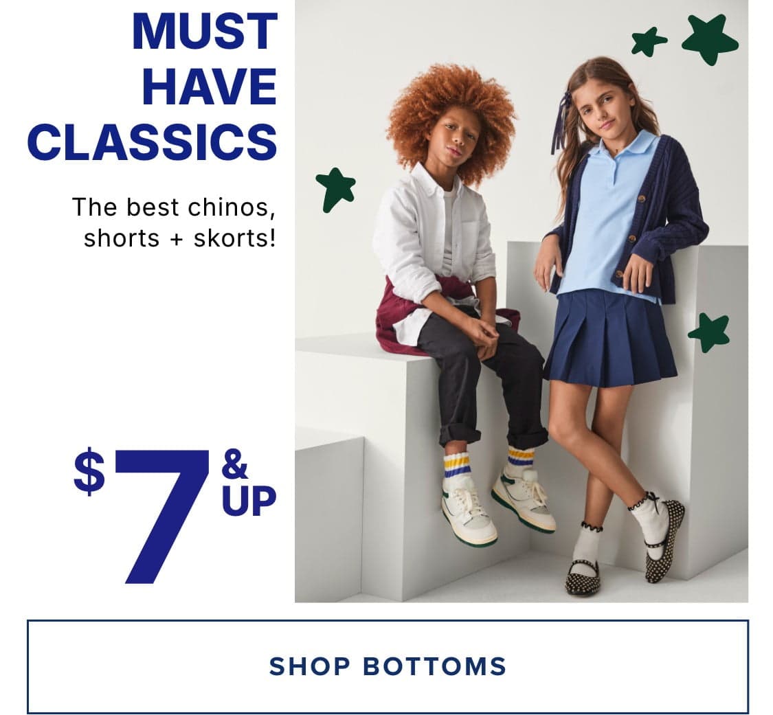 The image features two young individuals, a boy with curly red hair and a girl with long brown hair, posing against a plain white background. They are wearing various clothing items, including pants, shorts, and skirts, all of which are described as "must