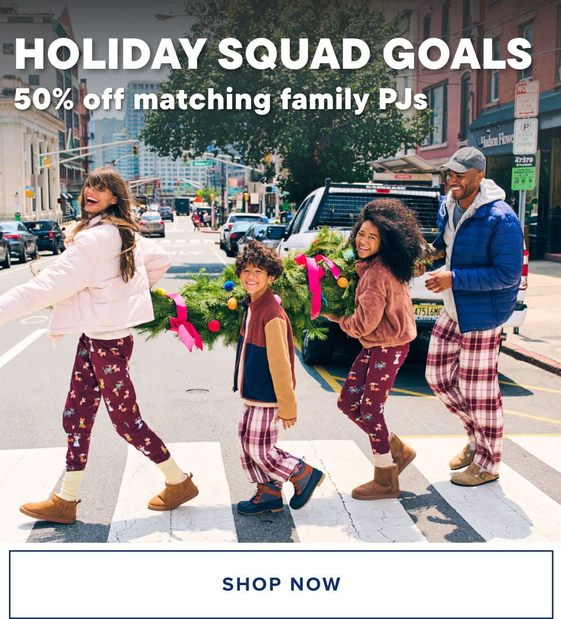 A group of young people, dressed in colorful and stylish outfits, are walking down a city street lined with storefronts and advertisements.