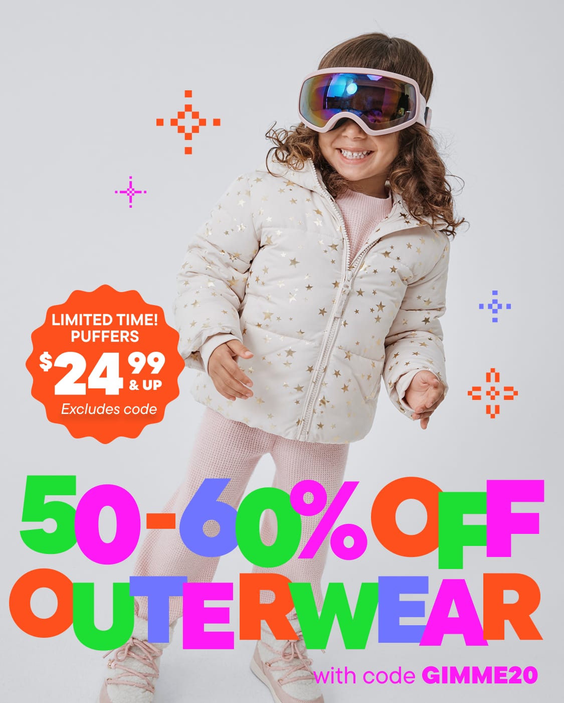 A young girl wearing a white polka-dot jacket and ski goggles stands in front of a colorful advertisement promoting up to 60% off on outerwear.