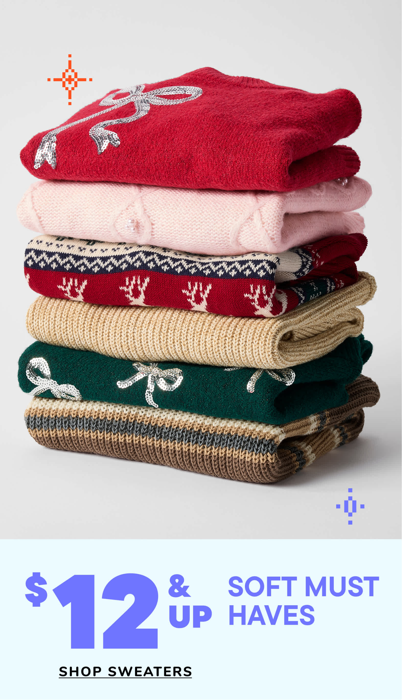 Two young girls wearing matching blue sweaters and jeans are standing together and smiling, with a "Soft Must Haves" advertisement in the background.