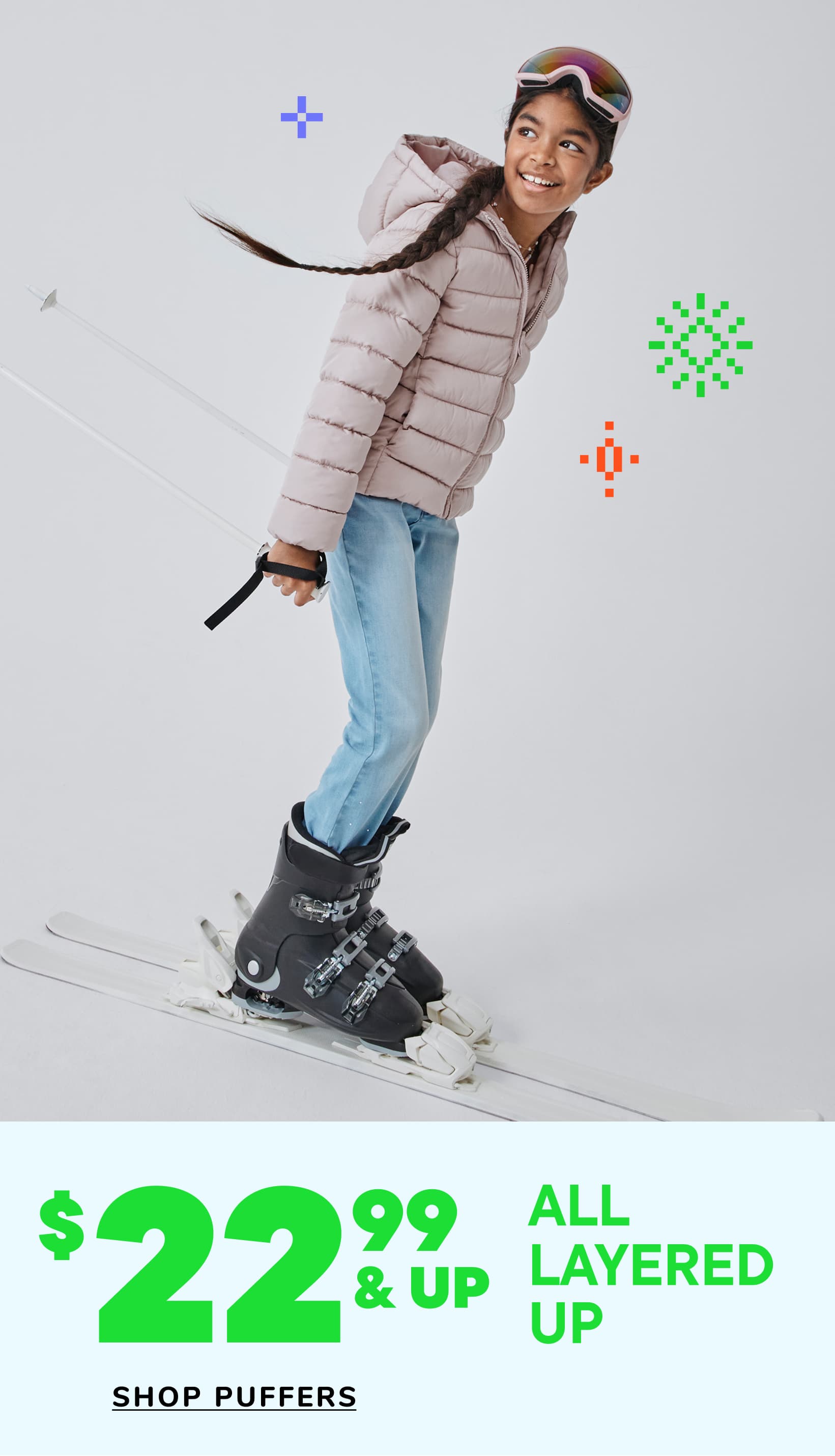 A young child with curly hair is smiling and wearing a navy blue puffy jacket, standing in front of a white background with colorful graphics.