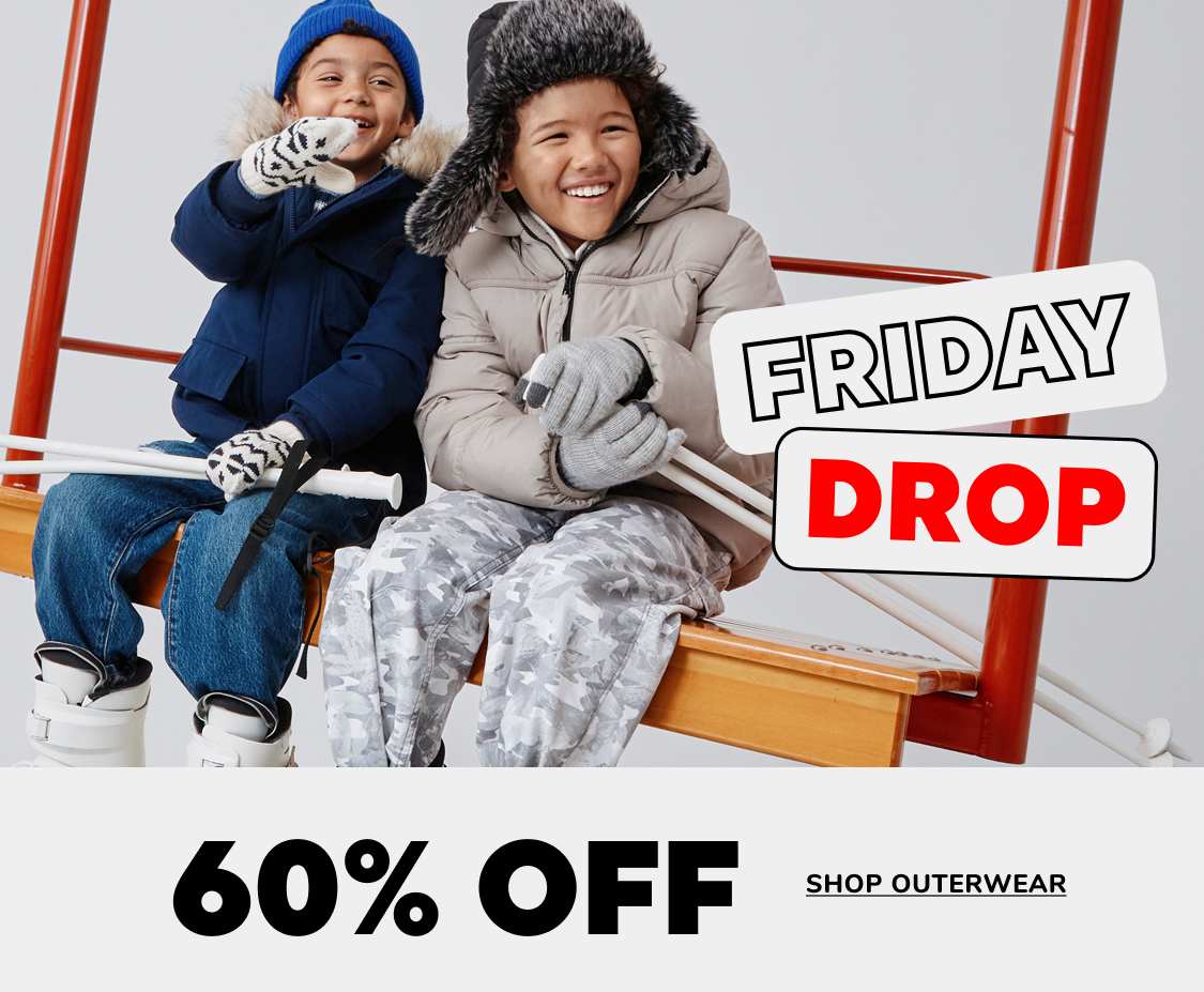 Two people, a young boy and girl, are sitting on a bench and smiling while wearing winter clothing. The background includes a sign advertising a "Friday Drop" sale with 60-70% off outerwear.