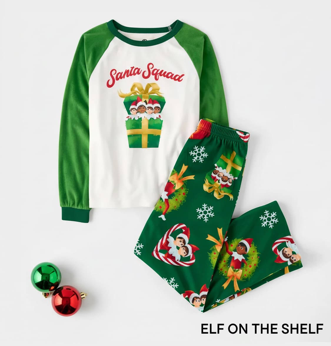 A neatly wrapped gift box featuring a festive elf-themed pattern on a navy blue background.