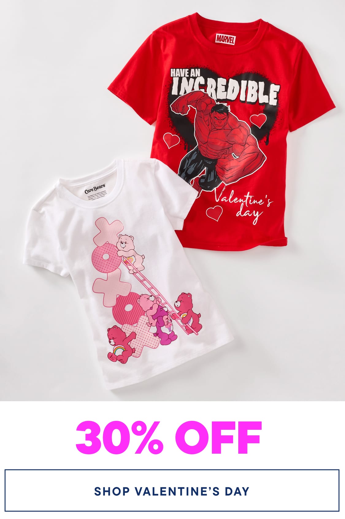 The image shows two red and white t-shirts with Valentine's Day-themed designs, including a large red character and pink flowers, against a plain white background.