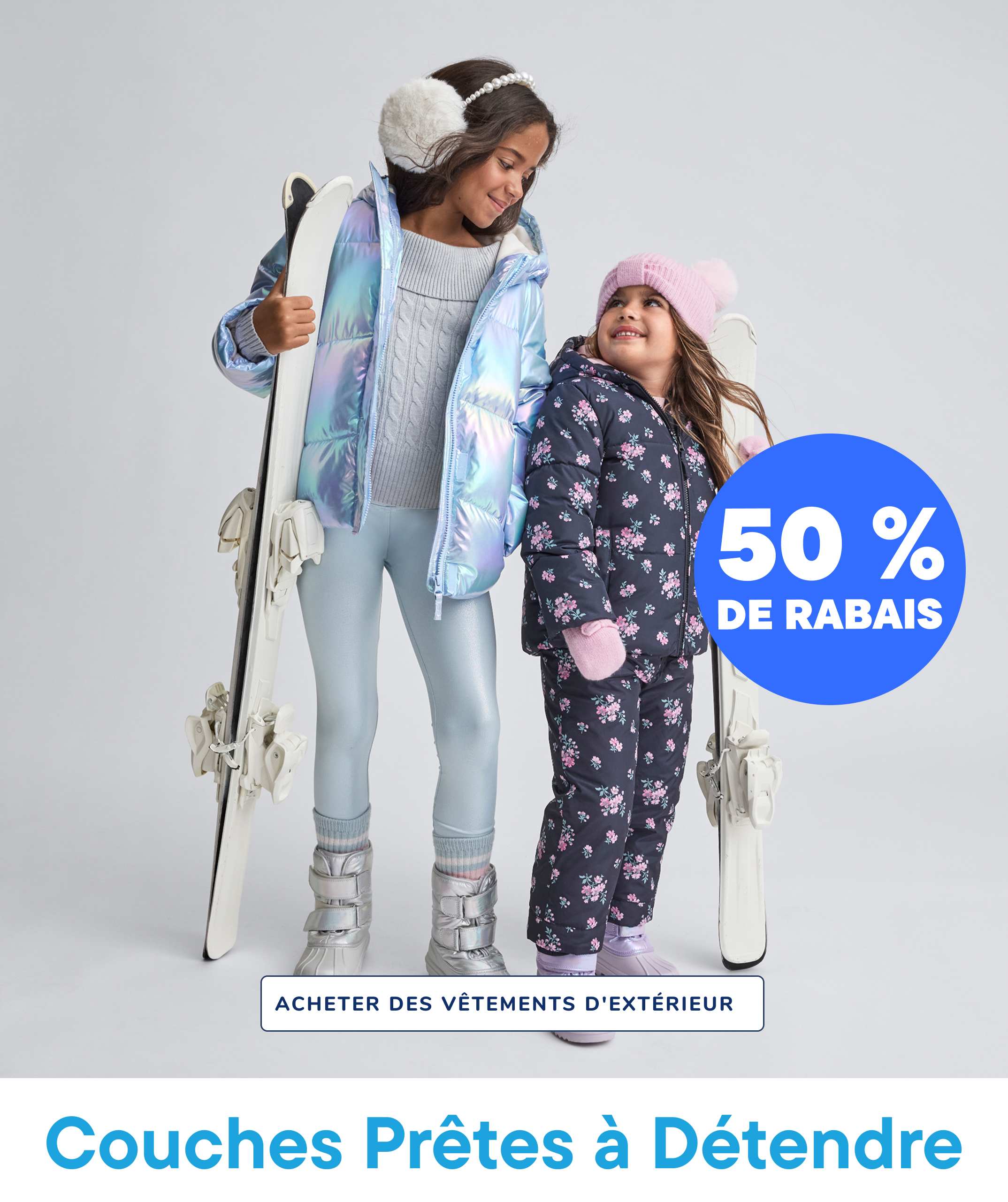 Two young girls wearing winter outfits and holding skis, with a large "50% OFF" text overlay and a "SHOP OUTERWEAR" call-to-action in the background.
