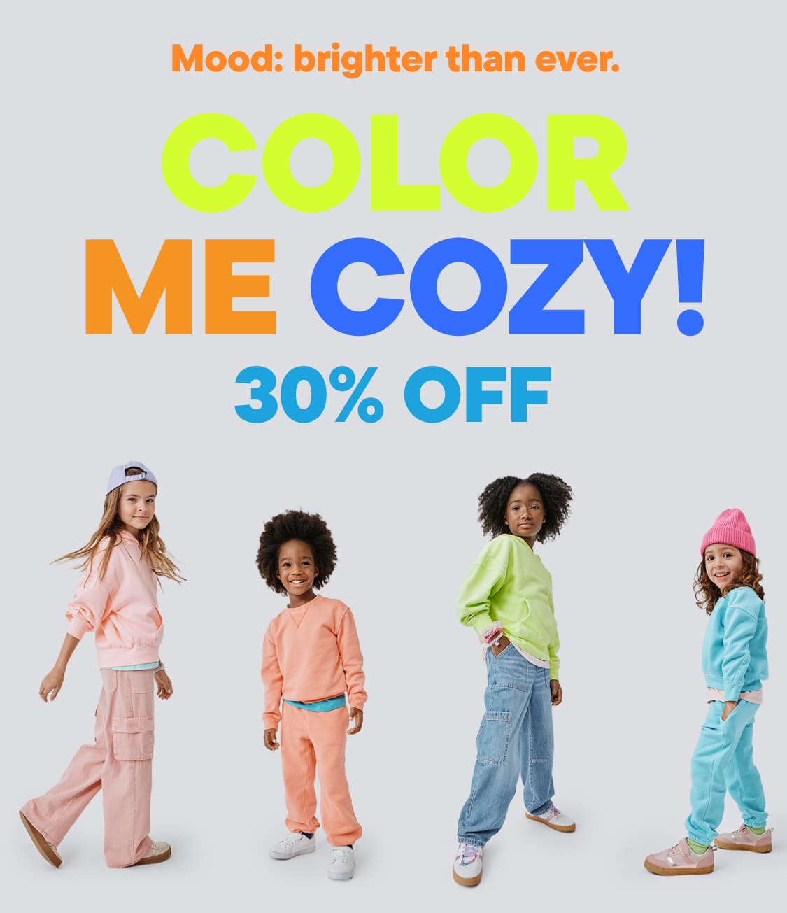 The image features a colorful advertisement for a clothing sale, showcasing a group of young models wearing vibrant, cozy-looking outfits against a plain background.