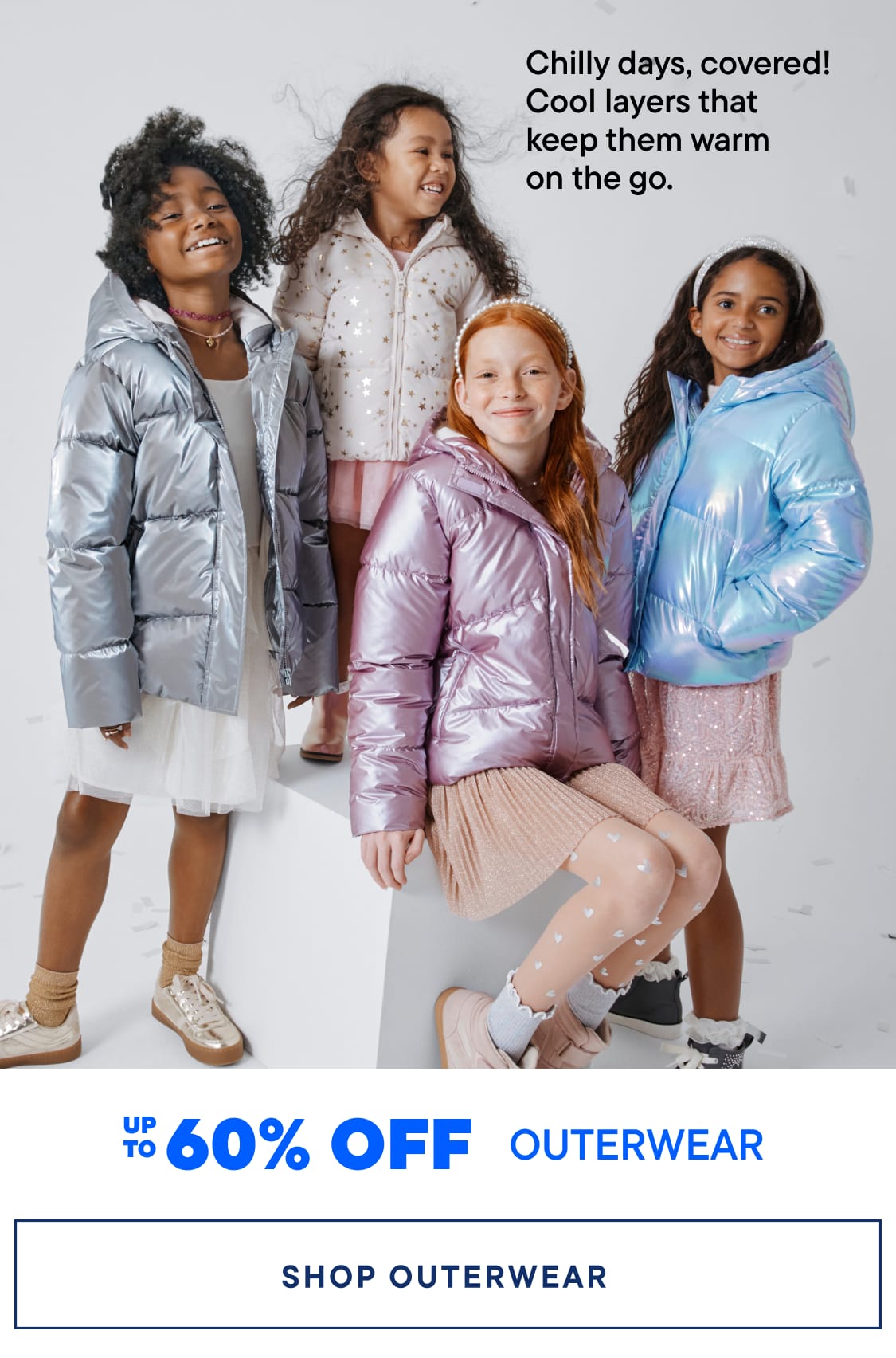 Two young children wearing winter outerwear, including a blue jacket and a pink puffy jacket, stand in front of a plain background with a promotional banner for outerwear discounts.