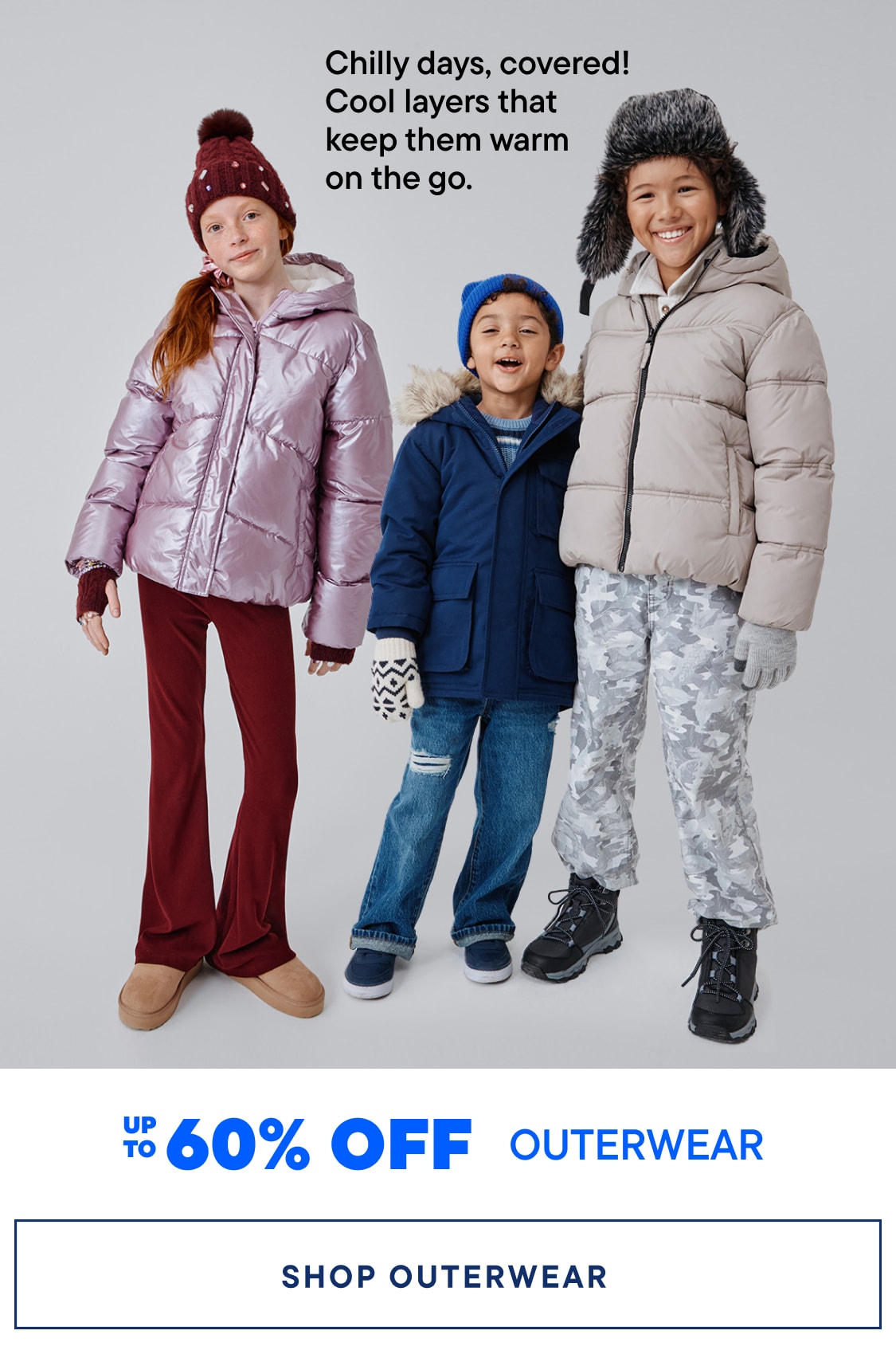 The image features three children dressed in warm winter outerwear, including coats, hats, and boots, standing against a plain background. The text overlay promotes a sale on outerwear, offering up to 60% off.