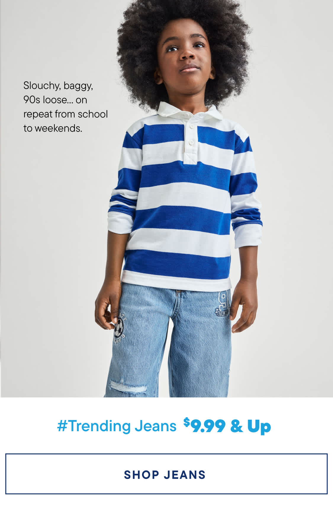 A young child with curly hair wearing a striped blue and white shirt and jeans stands against a plain white background, with text promoting trending jeans for $9.99 and up.