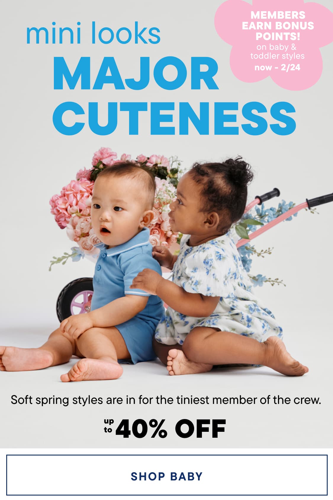 The image features two young children, a boy and a girl, sitting together on a floral background. The children are wearing colorful, spring-inspired outfits and appear to be engaging with each other in a playful and affectionate manner.