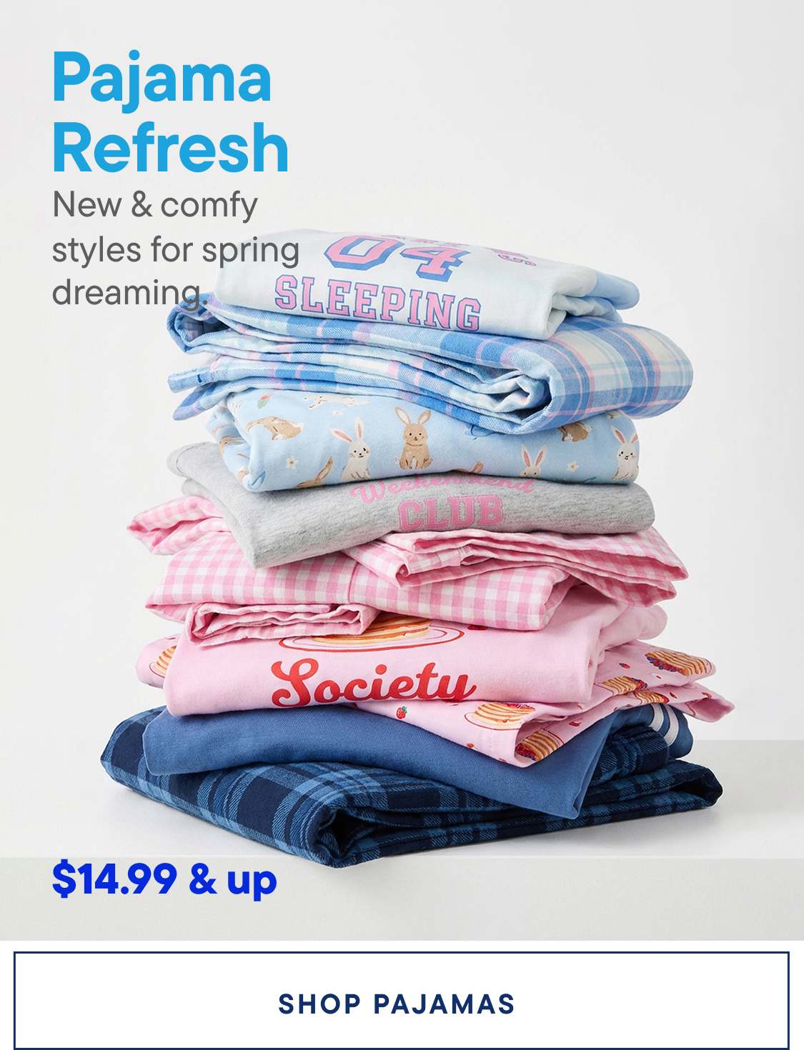 A stack of colorful and patterned pajamas, including blue and pink designs, with text such as "Sleeping" and "Society" visible, against a plain white background.