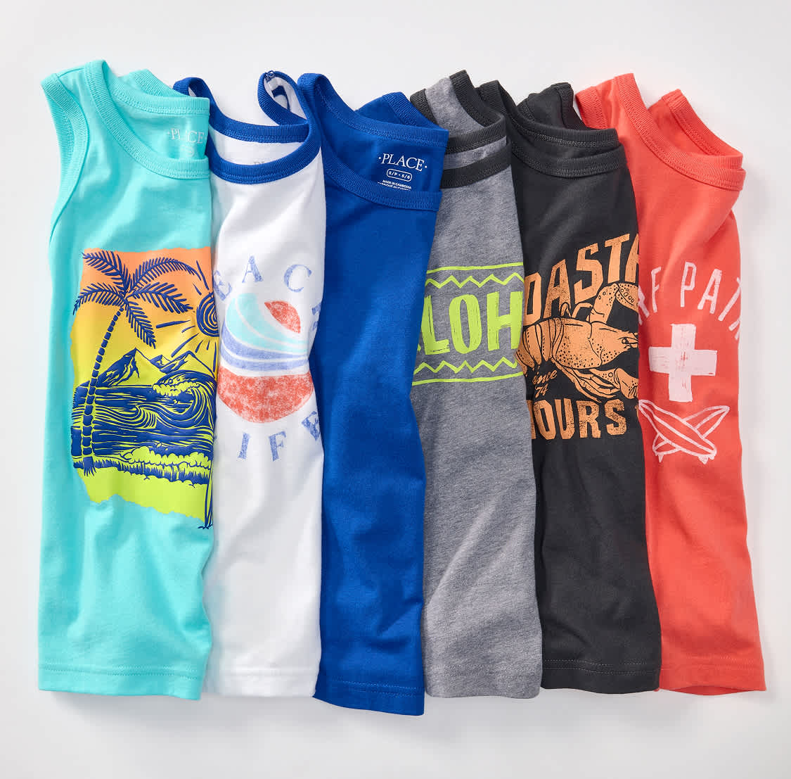 A row of colorful children's tank tops with various graphic designs are laid out against a plain white background.