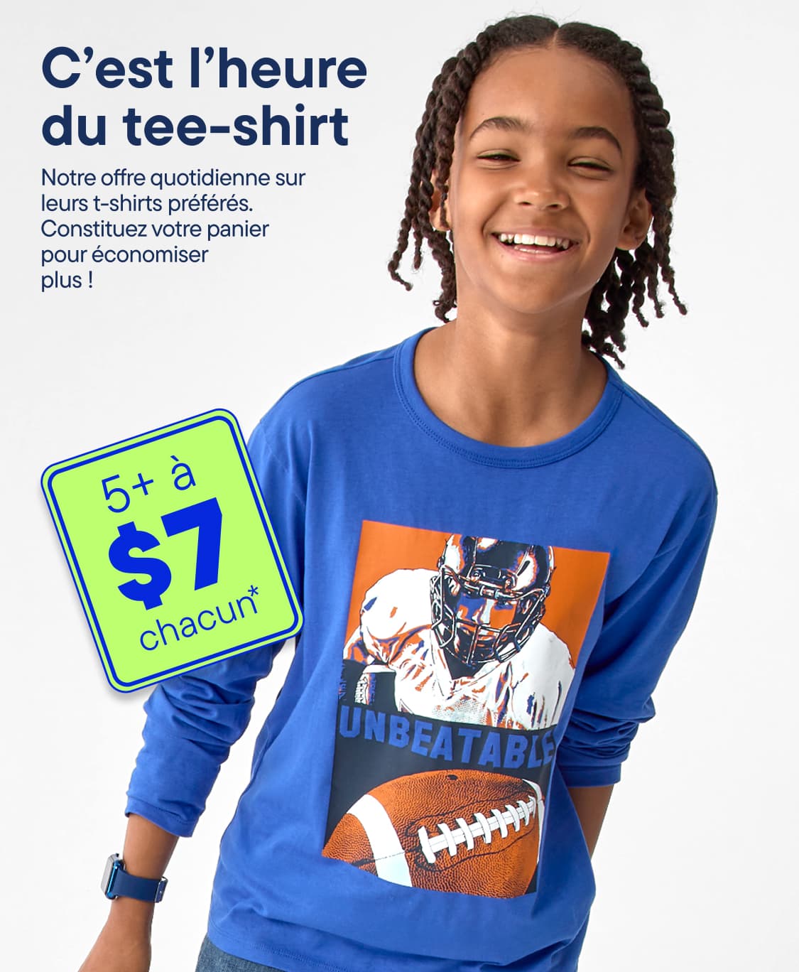 Un garçon souriant, vêtu d'un t-shirt bleu à manches longues orné d'un motif de football, se détache sur un fond gris clair, avec une pancarte verte annonçant une promotion au premier plan.