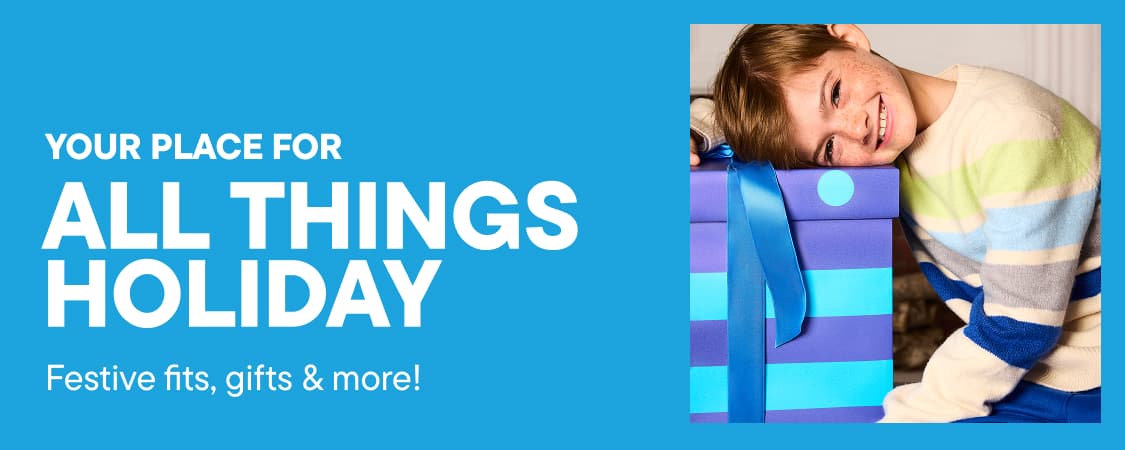 A smiling boy leans on a gift box on the left and a blue cartoon character holds presents on the right, set against a bright blue background with white holiday text.