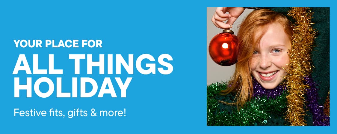 A smiling girl with a red ornament and tinsel is on the left, while a blue cartoon character with gifts is on the right, all set against a bright blue background with white holiday text.