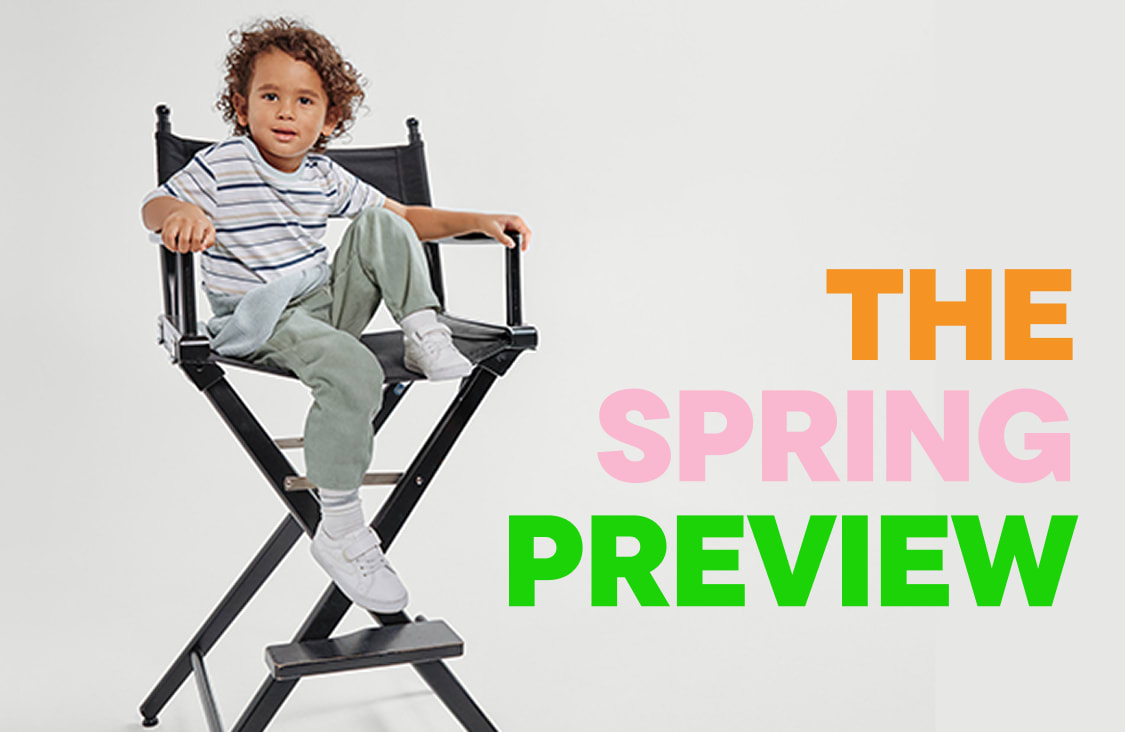 The image shows a white wall with the text "THE SPRING PREVIEW" displayed in large, colorful letters.