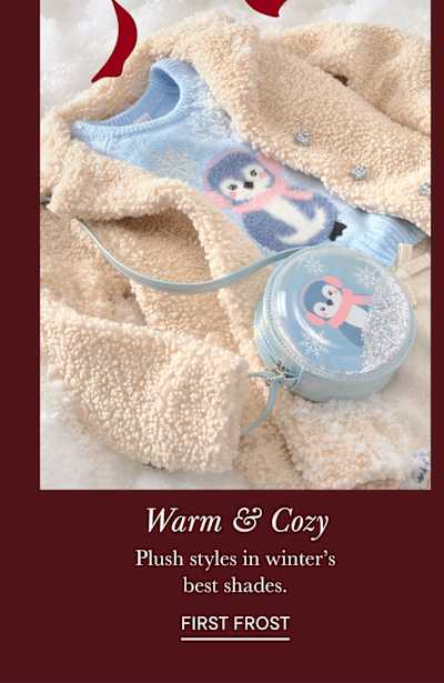 The image features a cozy and warm-looking plush toy, likely a sloth or similar animal, nestled in a soft, fluffy blanket. The background appears to be a winter-themed setting, with a snowy or icy texture visible.