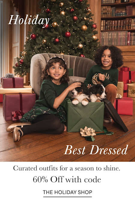 The image depicts a group of four young people, two men and two women, walking down a cobblestone street lined with buildings and surrounded by lush vegetation. The text overlay on the image promotes a "holiday like no other" and mentions "outfits on outfits for every tradition" along with a discount code.