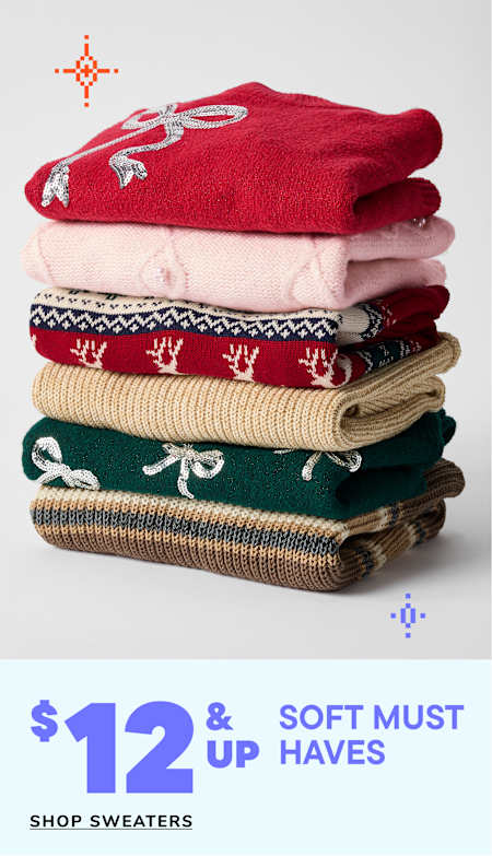 A stack of colorful, patterned sweaters with the text "$12 & up Soft must haves" displayed below.