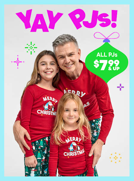 A family of three wearing matching red "Merry Christmas" shirts stands in front of a bright, colorful background with the text "Yay PJs!" and a price promotion for all PJs at $7.99 and up.