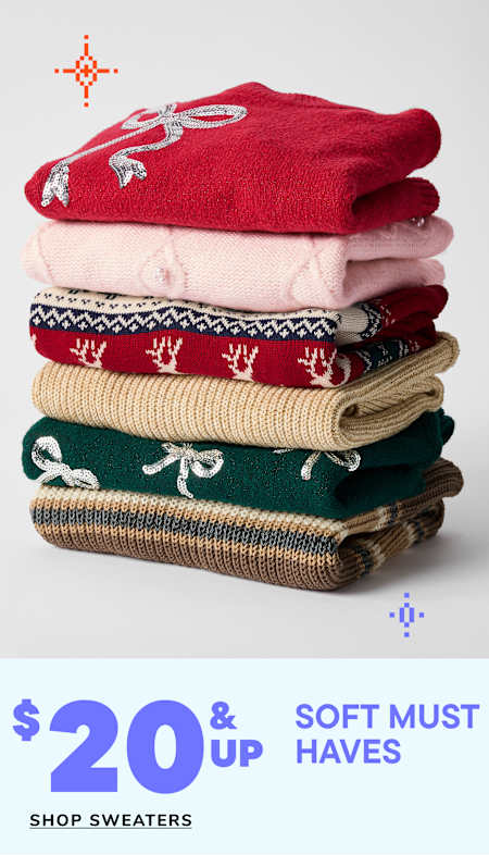 A stack of colorful, patterned sweaters with the text "$12 & up Soft must haves" displayed below.