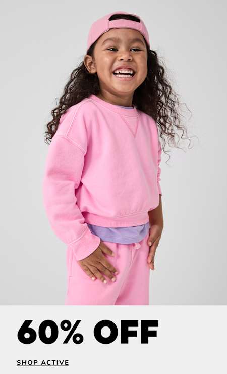 A young girl with curly hair wearing a pink sweatshirt and headband is smiling brightly against a plain white background, with a "60% OFF" text overlay.