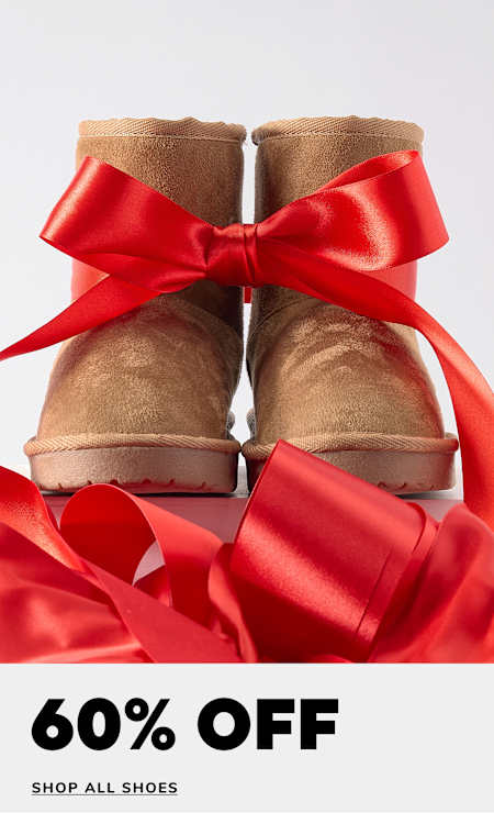 A pair of brown leather boots with red laces and a smiley face sticker on a plain background, accompanied by a 50% off sale promotion for boots.