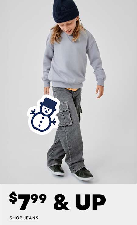 A young person with curly hair wearing a bright green puffy jacket and loose-fitting jeans stands against a plain white background, with a "60% OFF SHOP JEANS" text overlay.