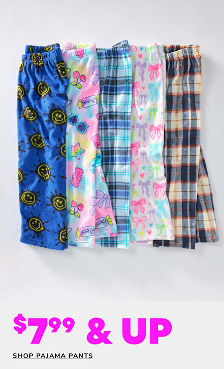 A collection of colorful and patterned pajama pants, including designs with smiley faces, plaid, and floral prints, displayed on a plain white background with a price tag of $7.99 and up.
