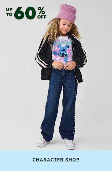 A young girl with curly hair wearing a black jacket, a pink hat, and a t-shirt with a cartoon character, standing in front of a background with a 60% off sale sign.