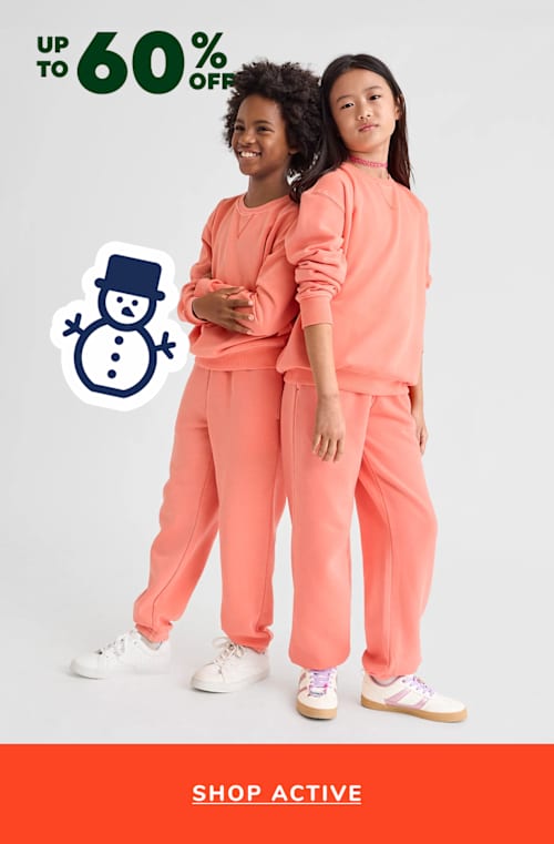 Dos chicas jóvenes que visten trajes de color rosa brillante a juego están paradas frente a un fondo blanco con un cartel de oferta de "Hasta 60% de descuento" y un ícono de muñeco de nieve.