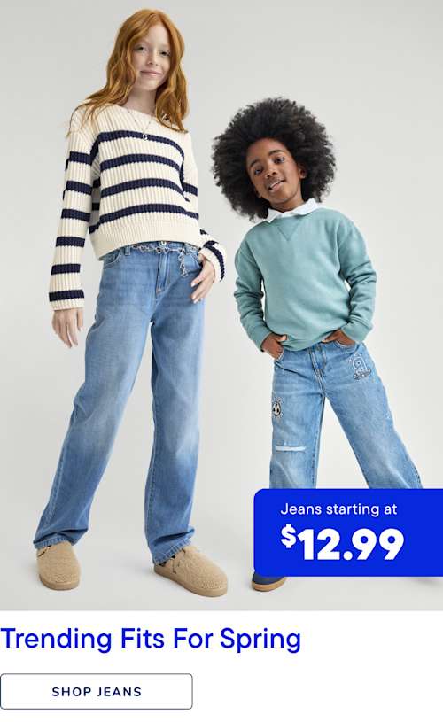 The image features two young individuals, one with long, curly red hair and the other with short, dark hair, both wearing casual clothing and posing in front of a plain background with a sign advertising jeans starting at $12.99.
