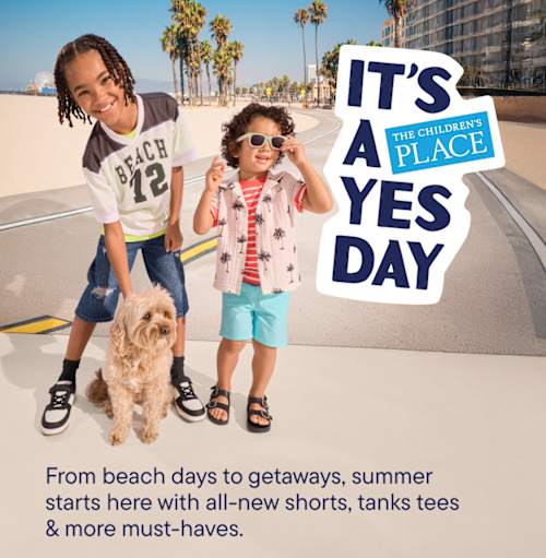 The image shows two young children, a girl and a boy, standing in front of a sign that says "IT'S A YES DAY" on a sunny beach with palm trees in the background.