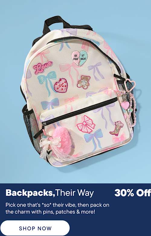 A pastel backpack adorned with bows and cute patches sits in the foreground against a solid blue background.