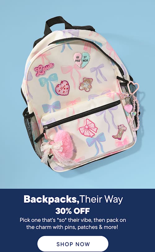 A pastel backpack adorned with bows and cute patches sits in the foreground against a solid blue background.