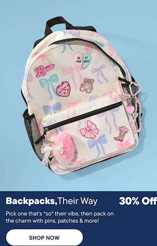 A pastel backpack adorned with bows and cute patches sits in the foreground against a solid blue background.