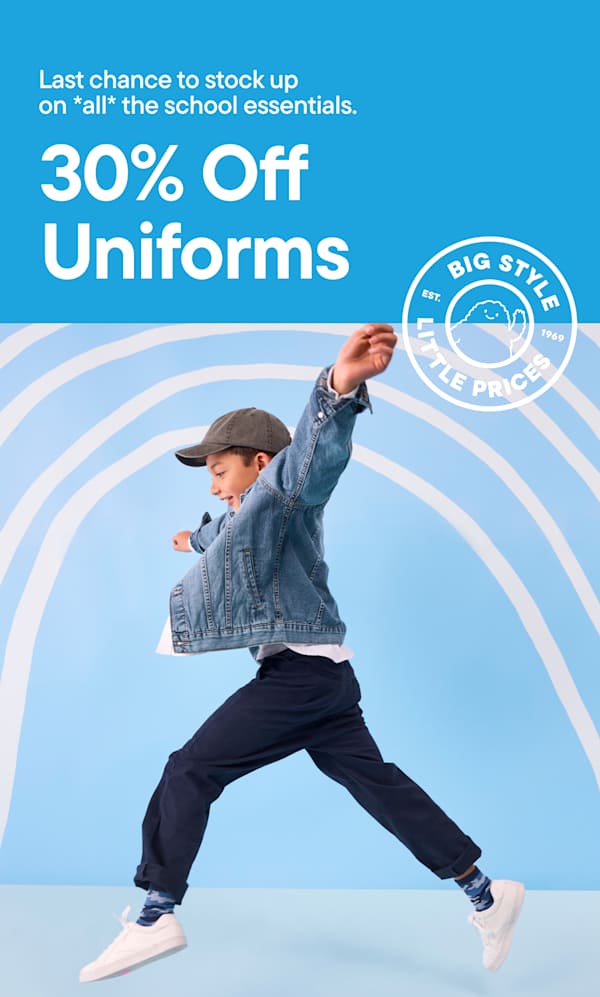 A young boy in a denim jacket and cap jumps in the foreground against a light blue background with white curved lines | 30% OFF UNIFORMS