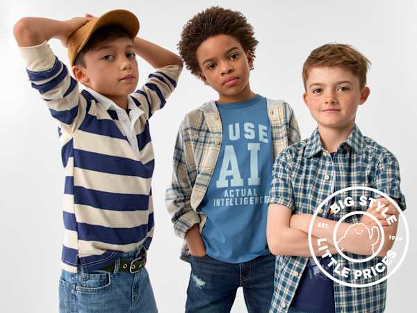 Three young boys in casual clothing pose against a plain white background.