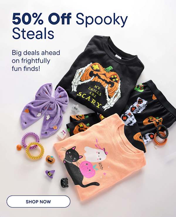 Halloween-themed children's clothing and accessories are arranged in the foreground against a plain white background.